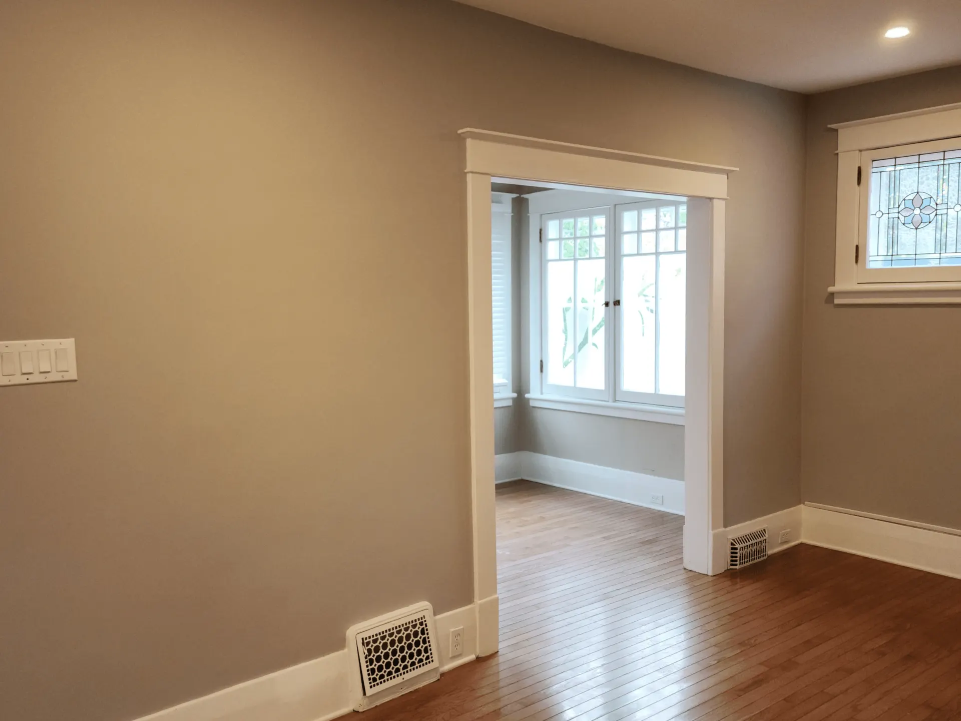 Freshly painted interior with white trim and hardwood floor